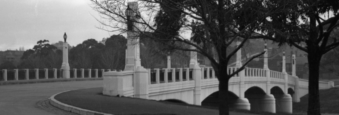 Black and white photo of bridge over river