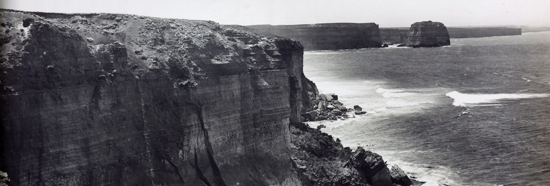 black and white photo of rocky mountain and ocean