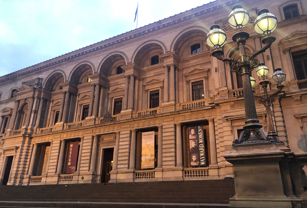 current photo of old treasury building, early evening, lights glowing