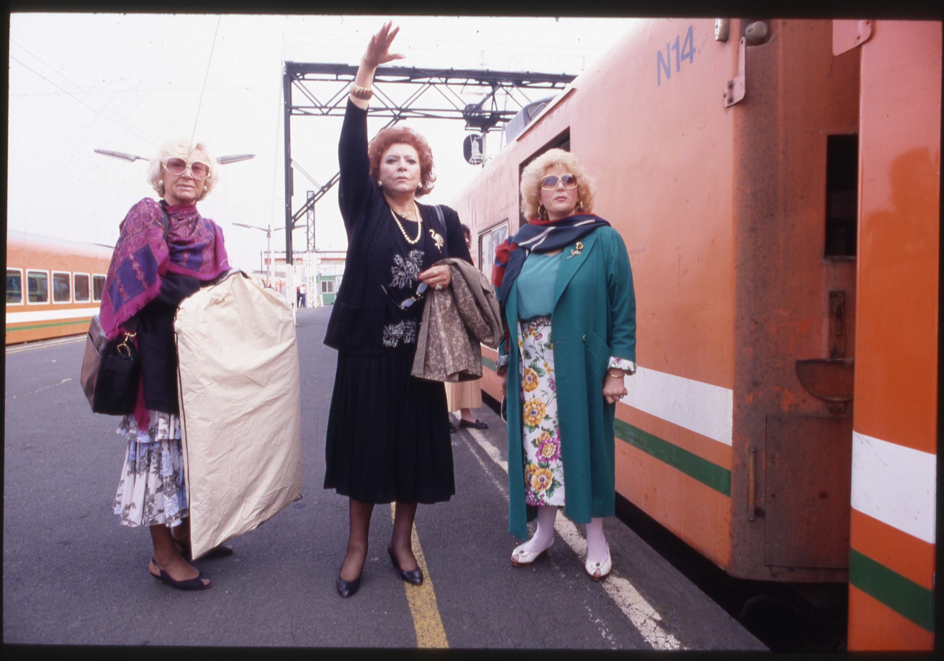 Older women hailing a train 