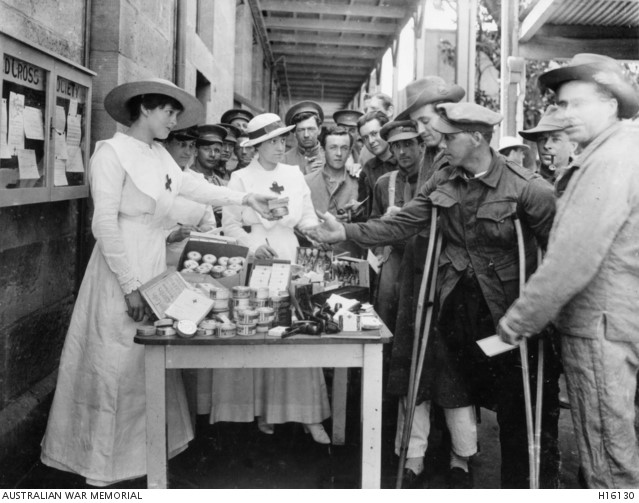 Ladies of the Red Cross Society distributing comforts to wounded men