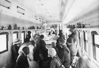 photo of a crowd on a train with their backs to the camera 