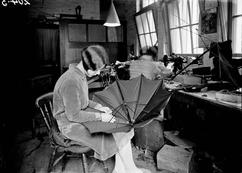 woman making an umbrella in a factory