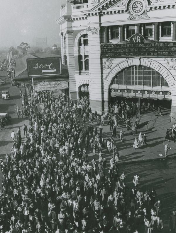 black and white photo of flinders st station with crowd