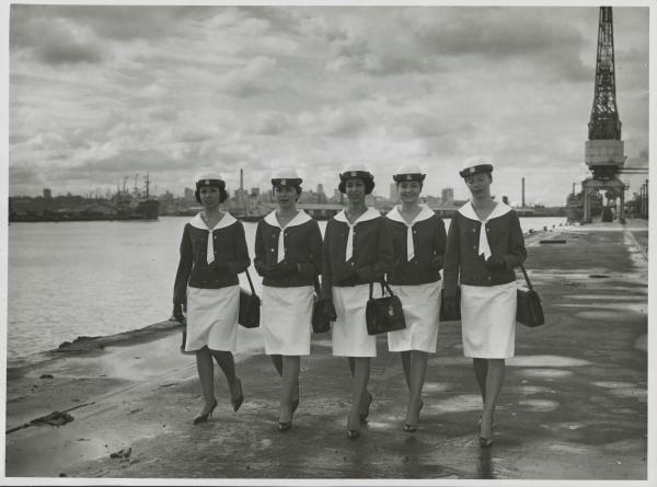 woman walking down dock in uniform
