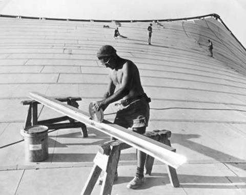 Black and white worker constructs Myer Music Bowl 
