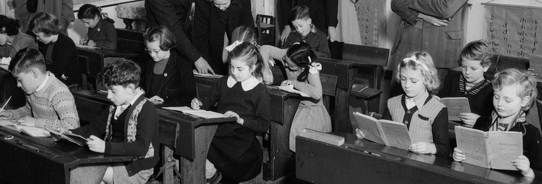 Black and white photo, school children in class