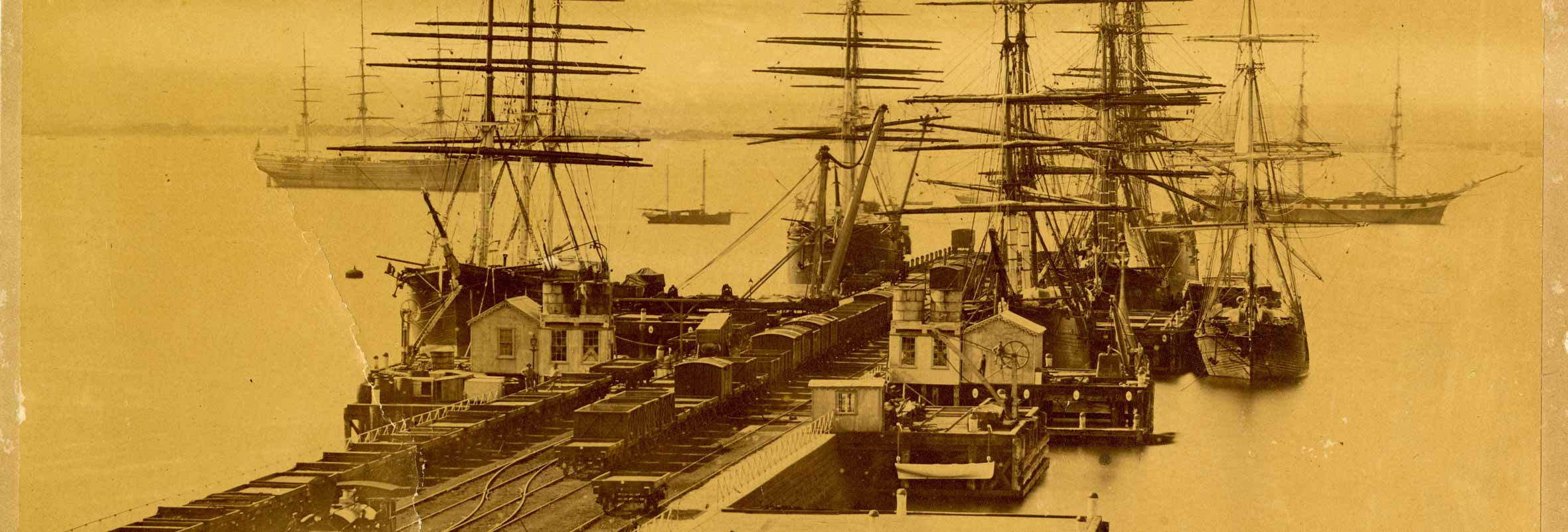 Image of tall ships docked at pier