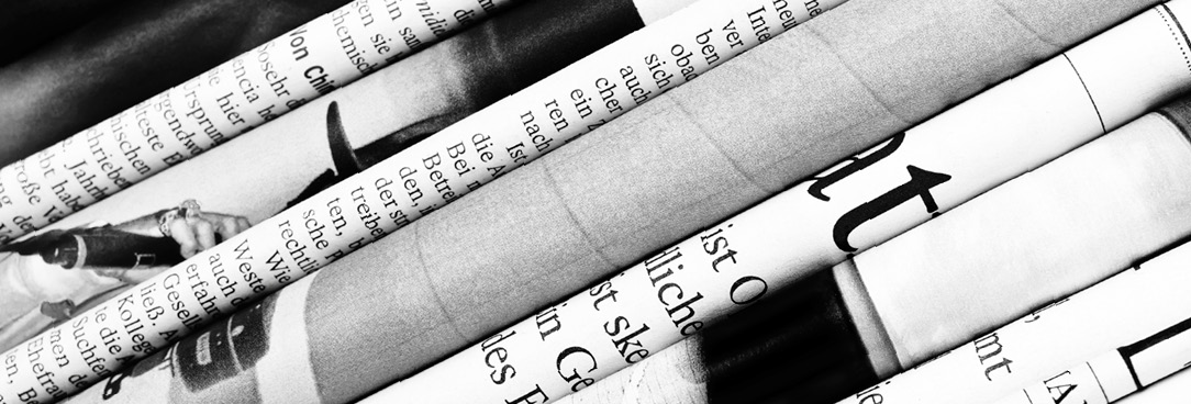 Black and white photo of a stack of newspapers