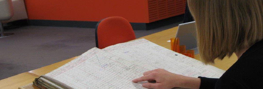 One of our volunteers reviewing an archival record for metadata A volunteer reading an archival book