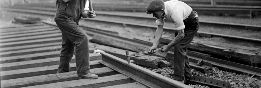 Black and white photo of men working on railway tracks