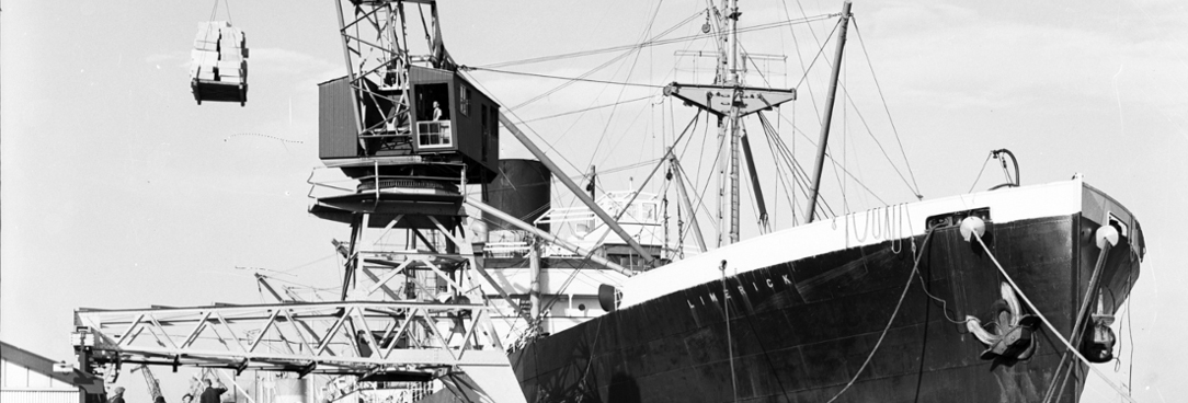 Black and white photo of a docked ship