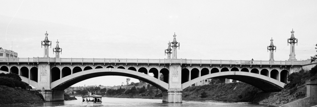 Black and white photo of bridge over a river