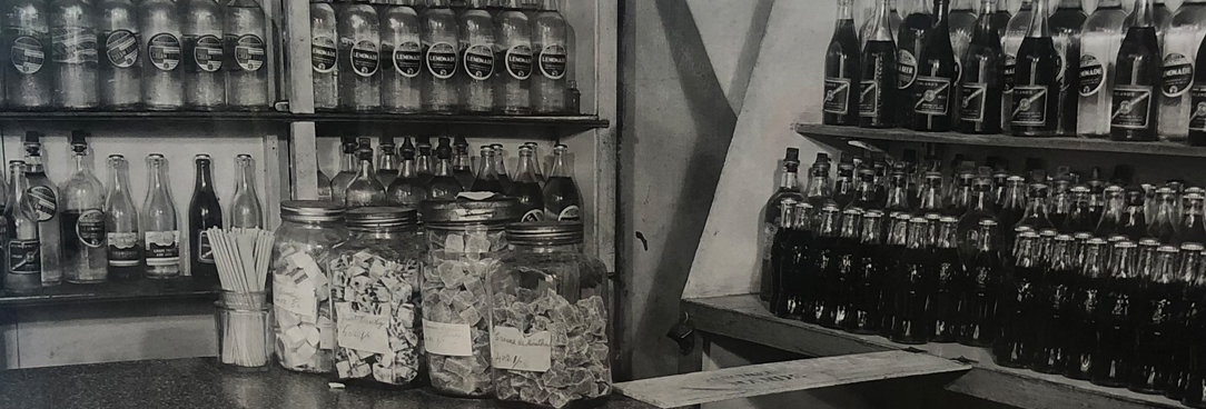 black and white photo of inside an old shop, it is a crime scene photo
