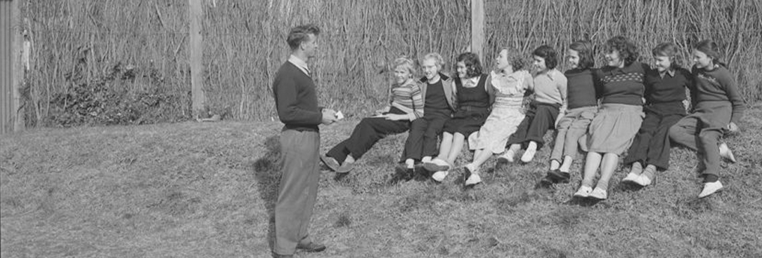 a group of children sitting on grassy ground