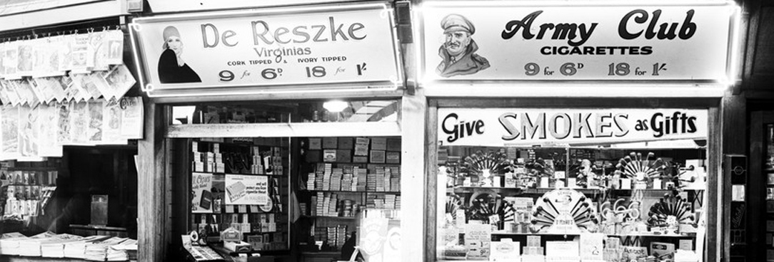 black and white photo of an old canteen kiosk with cigarettes on sale