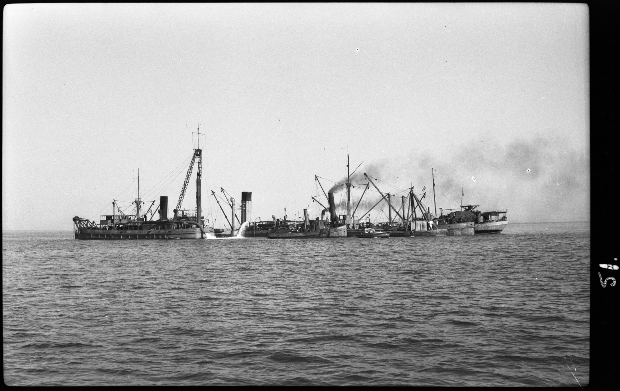 black and white photo of ships on ocean