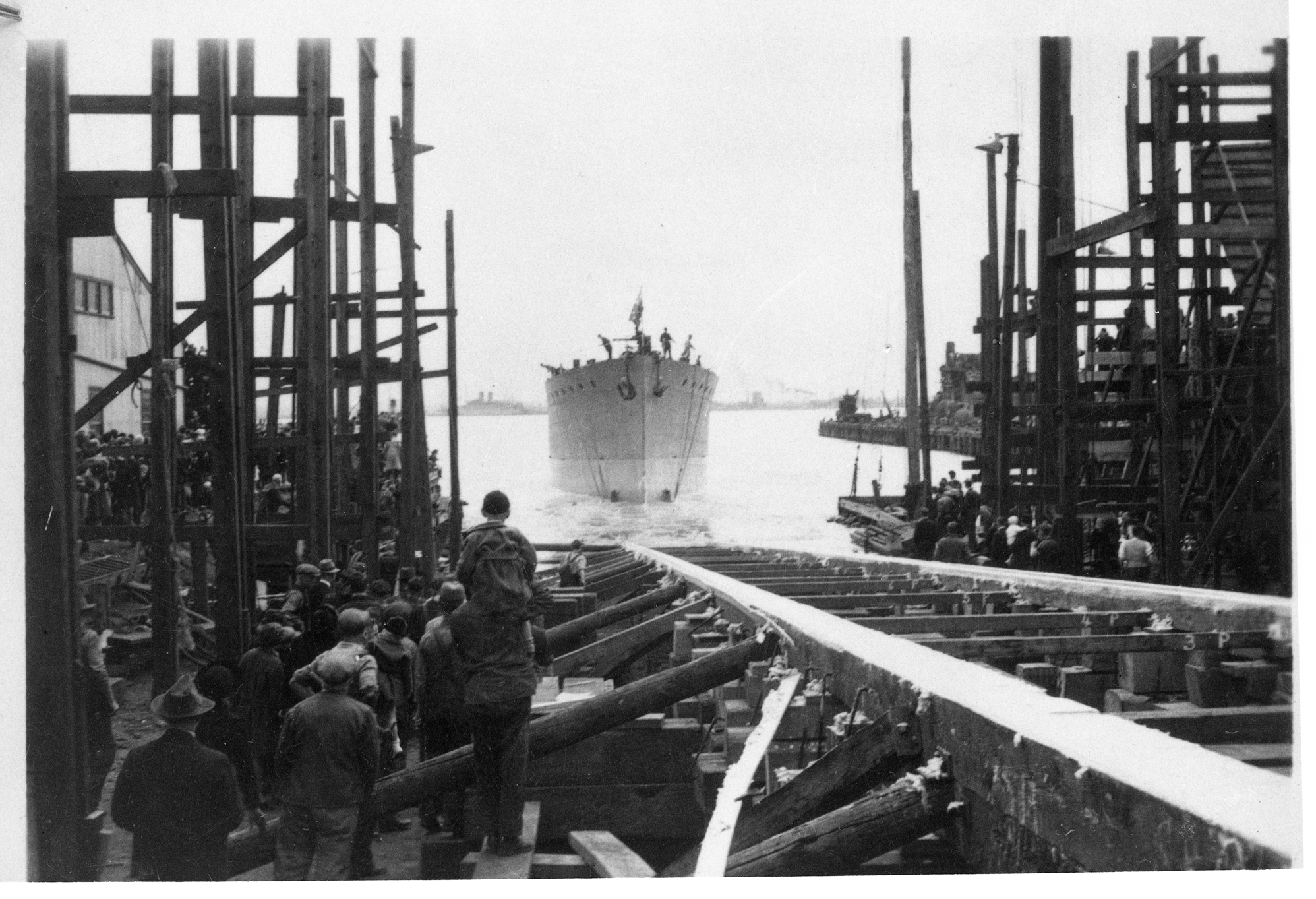 black and white image of a ship coming into dock