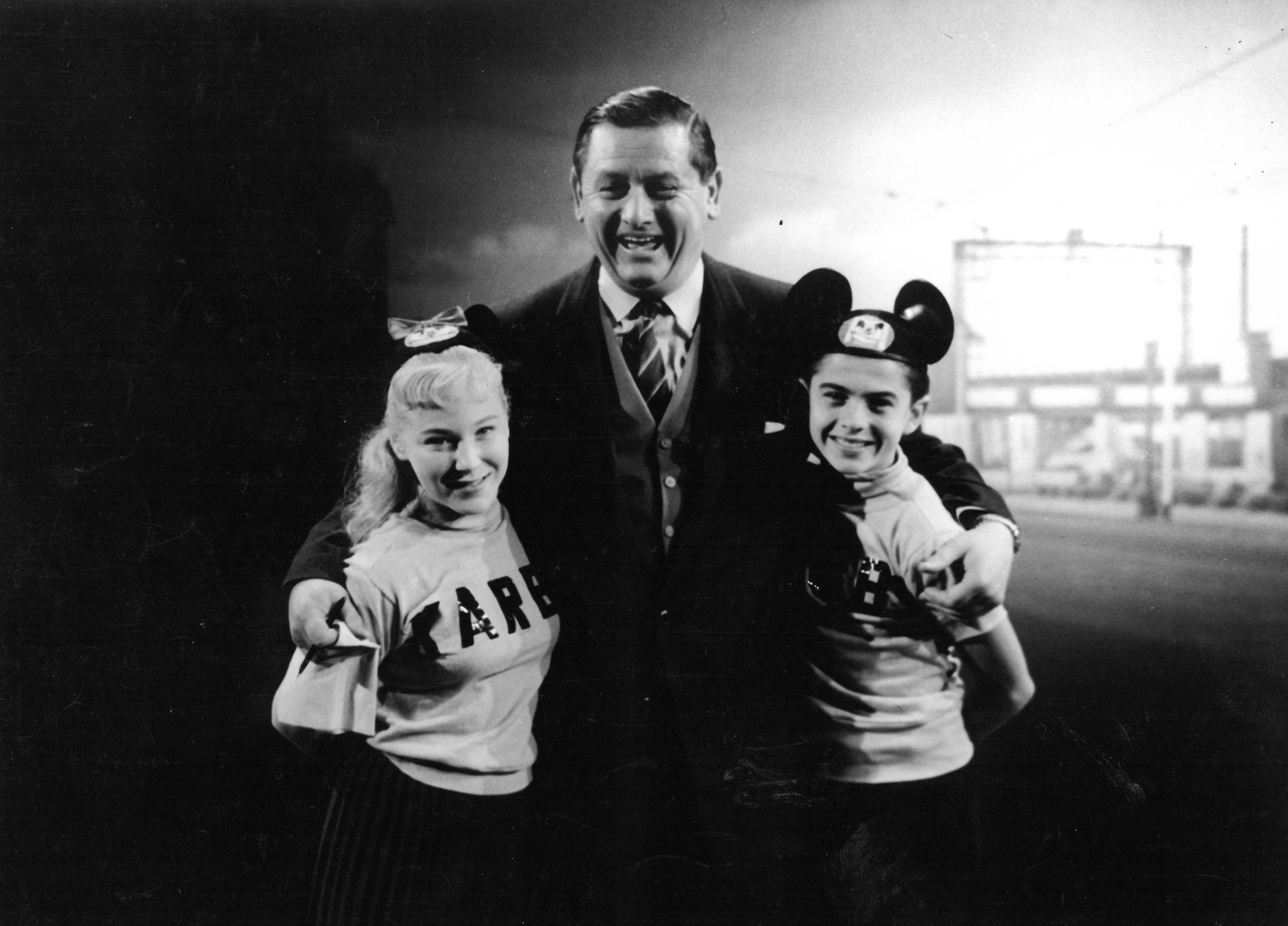 black and white photo of two mousekteers with a man