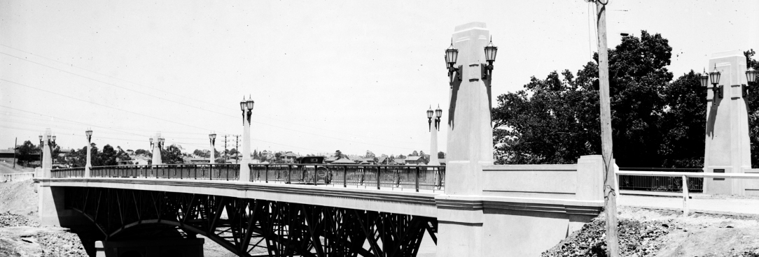Black and white photo of a bridge over a river