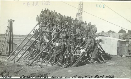 several men putting up a building frame 