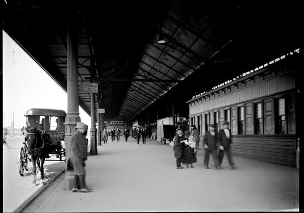 Black and white photo of people at Flinders Street Station with Horse and Cab