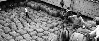 Black and white photo of crew unloading a ship