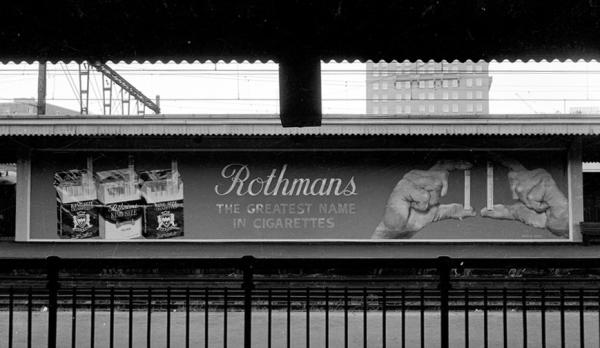 black and white photo of a billboard for rothmans