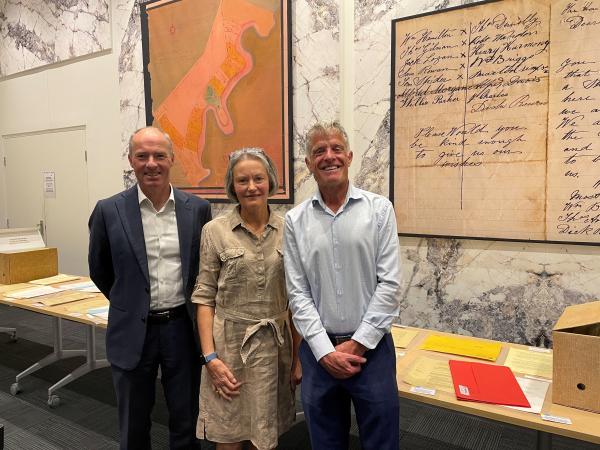 three people smiling at camera