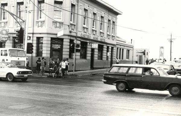 outside a pub, cars driving by