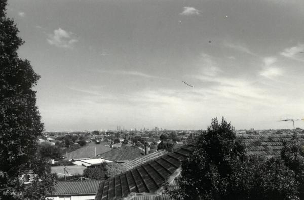 a view of the city from rooftops in the suburbs