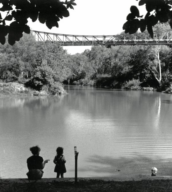 a woman and two children at a lake