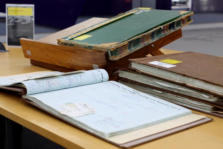 Colour photograph of old ledgers on a table