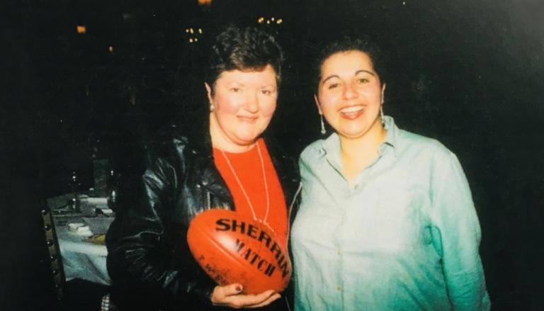 Colour photograph of Joan Kirner and Hutch Hussein. Kirner is holding a football.