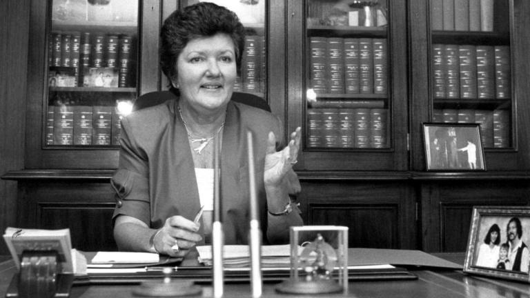Black and white photograph of Joan Kirner sitting behind her desk