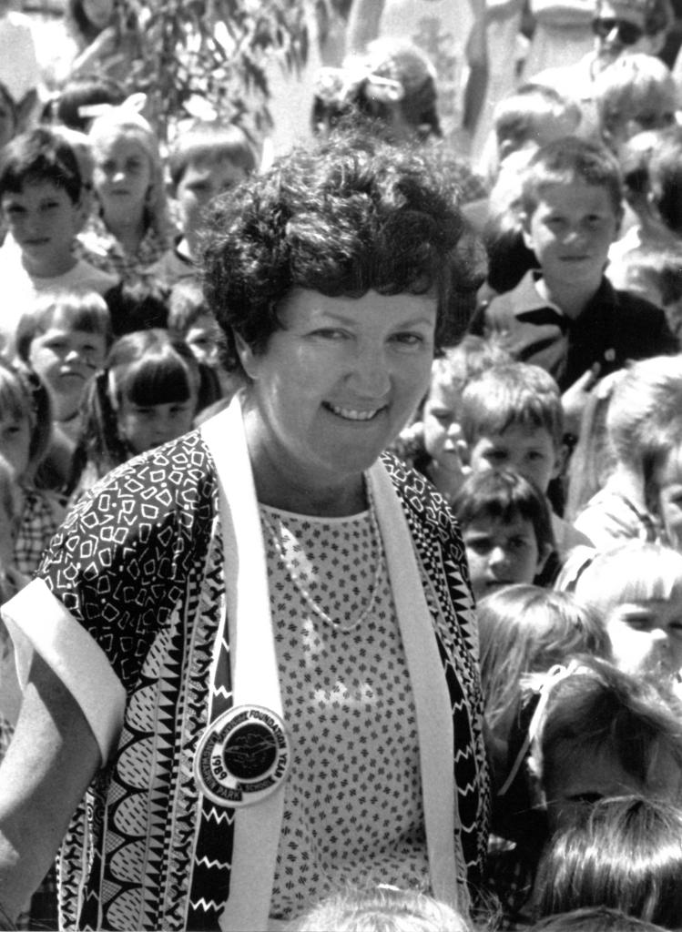 Black and white photograph of Joan Kirner in 1989 with school children in the background